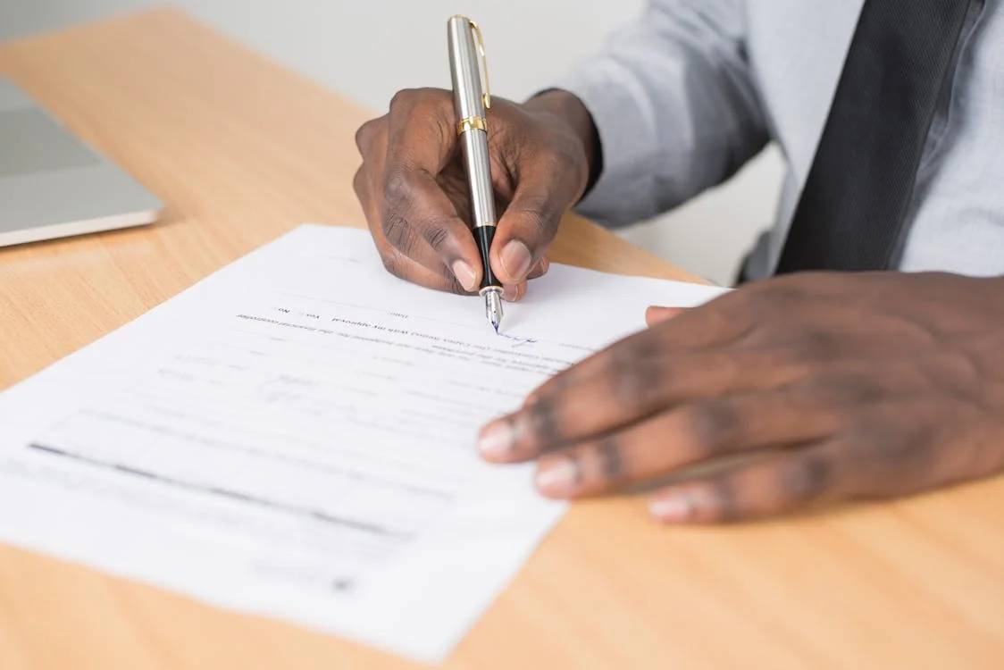 Stock photo of a man signing a paper