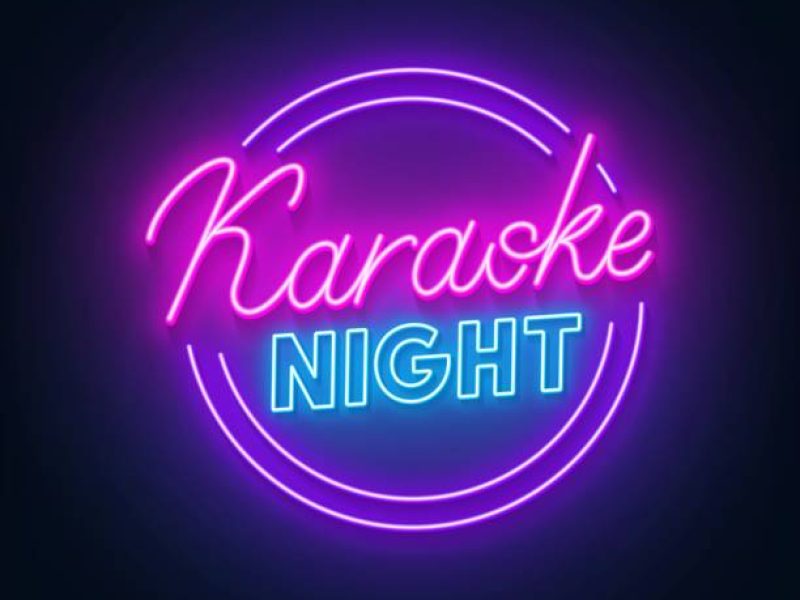 Karaoke night neon sign on dark background .